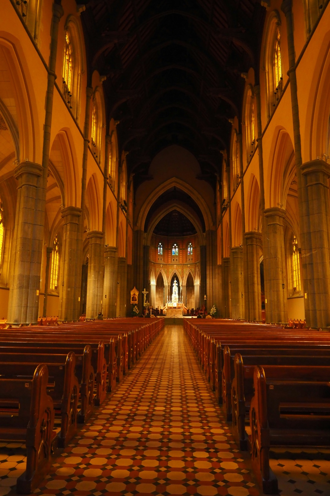 Rows of wooden pews inside a light-filled church